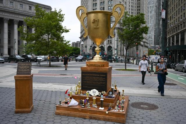 A satirical "Iran War Participation Trophy" is seen in Lower Manhattan in New York City on July 30, 2026. The satirical work is the latest installment by a group of anonymous artists that aim to mock US President Donald Trump. (Photo by Angela WEISS / AFP)