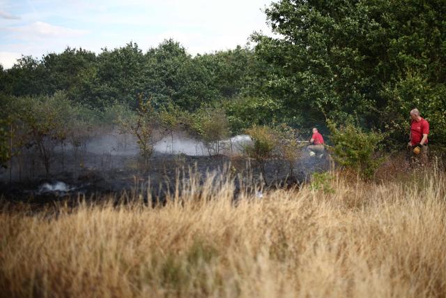 Firefighters work at the site of a wildfire in Hornchurch, east of London, on July 30, 2026. (Photo by Henry Nicholls / AFP)