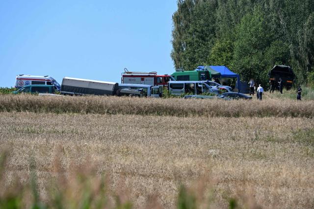 Vehicles and police officers, soldiers and firefighters work an area near the village of Tarnawa-Kolonia, eastern Poland, 30 July 2026, where a flying object hit the ground and exploded in the early hours of the day, the fire service reported. Residents of this locality in the Lublin region heard, shortly before 4:00 a.m. (2:00 a.m. GMT), a powerful explosion that shook the windows of their homes. The impact site is located around 80 km from the Ukrainian border. NATO said on July 30 it was in close contact with Warsaw as it blamed Russia for a missile that crashed in Poland, and vowed to "continue to take all necessary measures to defend" alliance territory. (Photo by Wojtek JARGILO / PAP / AFP) / Poland OUT