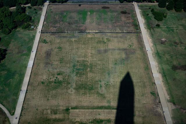 The shadow of the Washington Monument is cast on a portion of the National Mall where the faint lettering of “8-6-4-7” can be seen in Washington, DC on July 30, 2026. (Photo by Kent Nishimura / AFP)