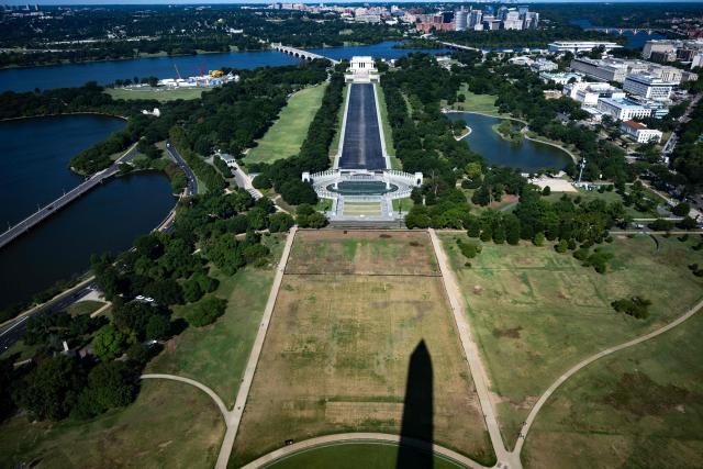 The shadow of the Washington Monument is cast on a portion of the National Mall where the faint lettering of “8-6-4-7” can be seen in Washington, DC on July 30, 2026. (Photo by Kent Nishimura / AFP)