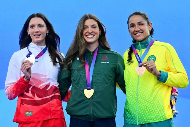 (From L) Silver medallist England's Jade O'Dowda, gold medallist Northern Ireland's Katherine O'Connor and bronze medallist Australia's Tori West celebrate on the podium after competing in the women's heptathlon during the athletics event at the Scotstoun Stadium in Glasgow, on day seven of the Commonwealth Games in Glasgow, Scotland, on July 30, 2026. (Photo by ANDY BUCHANAN / AFP)