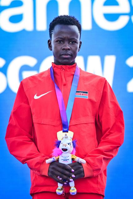 Gold medallist Kenya's Faith Cherotich celebrates on the podium after competing in the women's 3000m steeplechase during the athletics event at the Scotstoun Stadium in Glasgow, on day seven of the Commonwealth Games in Glasgow, Scotland, on July 30, 2026. (Photo by ANDY BUCHANAN / AFP)
