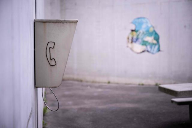 This photograph shows a phone cabin in the outdoor courtyard of the third organised crime unit (drug-trafficking district) during a press tour at Reau Prison, near Paris on July 30, 2026. A third organised crime unit is set to open in France in the coming weeks, at Reau prison (Seine-et-Marne), one year after the first such unit opened in Pas-de-Calais, the prison service announced on July 30, 2026 during a press tour of the facility. (Photo by Lou BENOIST / AFP)