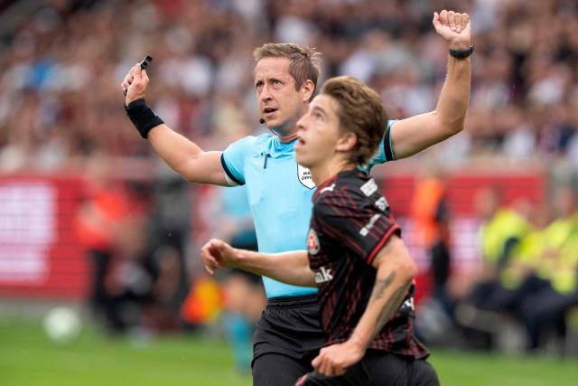 British referee John Brooks (L) reacts during the UEFA Europa League second qualifying round second leg football match between FC Midtjylland and Besiktas JK in the MCH Arena in Herning, Denmark, on July 30, 2026. (Photo by Bo Amstrup / Ritzau Scanpix / AFP) / Denmark OUT