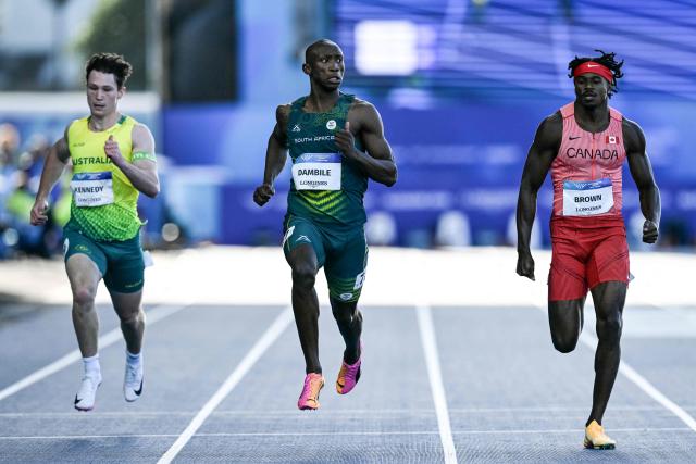 (From L) Australia's Lachlan Kennedy, South Africa's Sinesipho Dambile and Canada's Aaron Brown compete in the men's 200m semi-final 3 during the athletics event at the Scotstoun Stadium in Glasgow, on day seven of the Commonwealth Games in Glasgow, Scotland, on July 30, 2026. (Photo by ANDY BUCHANAN / AFP)