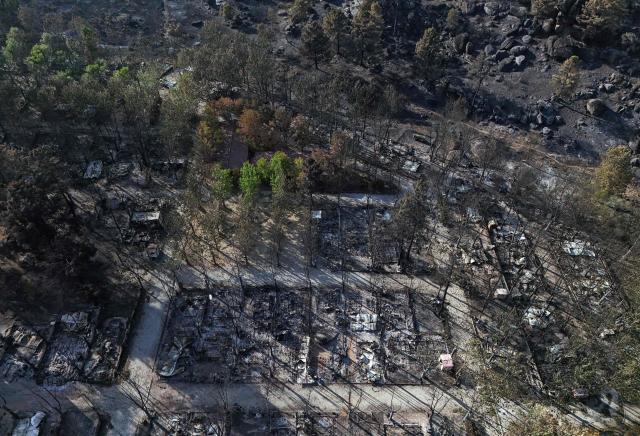 Aerial view of burnt pitches at the Valle de Iruelas camping, near El Tiemblo, in Avila province, Spain on July 30, 2026. Spanish Prime Minister Pedro Sanchez today lifted the state of emergency over the wildfires in Madrid and Avila regions that forced the evacuations of tens of thousands of people. Wildfires have stopped spreading and there are "almost no flames", Spanish authorities said. But they warned that the ongoing heatwave threatens a resurgence of fire in areas west of Madrid, where more than 25,000 hectares (61,776 acres) have already gone up in smoke. (Photo by OSCAR DEL POZO / AFP)
