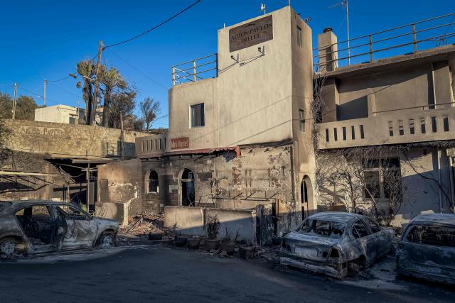 This photograph shows a destroyed hotel after a wildfire at the village of Agios Pavlos in the Greek island of Crete on July 30, 2026. Greece on July 30, 2026 battled to contain a spate of wildfires, including on the tourist island of Crete that forced thousands of locals and holidaymakers to evacuate, and left three firefighters dead. The Crete fire, south of the city of Rethymno, had forced officials to evacuate some 8,000 people overnight as it threatened the village resort of Agia Galini. (Photo by Will VASILOPOULOS / AFP)