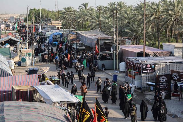 Shia pilgrims march through Baghdad's Dora district towards Karbala to take part in the Arbaeen pilgrimage on July 30, 2026. The Arbaeen marks one of the most significant events in the Shia Muslim calendar, during which pilgrims, many from Iran, flock to Iraq to visit the holy shrines. (Photo by AHMAD AL-RUBAYE / AFP)