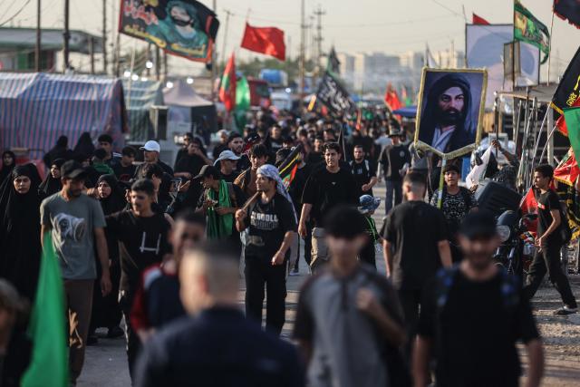 Shia pilgrims march through Baghdad's Dora district towards Karbala to take part in the Arbaeen pilgrimage on July 30, 2026. The Arbaeen marks one of the most significant events in the Shia Muslim calendar, during which pilgrims, many from Iran, flock to Iraq to visit the holy shrines. (Photo by AHMAD AL-RUBAYE / AFP)