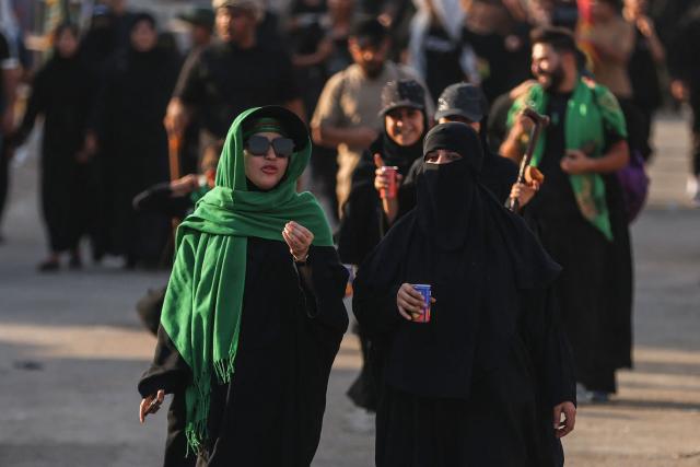 Shia pilgrims march through Baghdad's Dora district towards Karbala to take part in the Arbaeen pilgrimage on July 30, 2026. The Arbaeen marks one of the most significant events in the Shia Muslim calendar, during which pilgrims, many from Iran, flock to Iraq to visit the holy shrines. (Photo by AHMAD AL-RUBAYE / AFP)