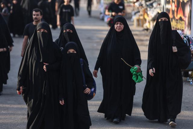 Shia pilgrims march through Baghdad's Dora district towards Karbala to take part in the Arbaeen pilgrimage on July 30, 2026. The Arbaeen marks one of the most significant events in the Shia Muslim calendar, during which pilgrims, many from Iran, flock to Iraq to visit the holy shrines. (Photo by AHMAD AL-RUBAYE / AFP)