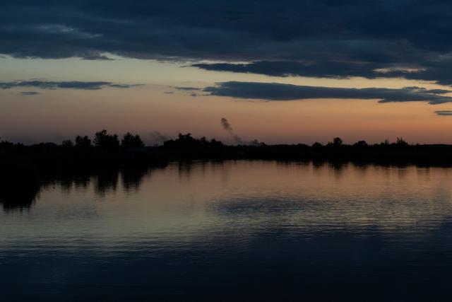 Smoke rises in the distance outside the city of Dnipro during a Russian air attack on July 30, 2026, amid the Russian invasion of Ukraine. (Photo by Roman PILIPEY / AFP)
