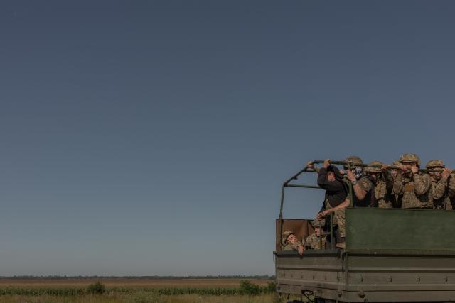 Ukrainian soldiers drive in a military truck along a road in the Kharkiv region on July 30, 2026, amid the Russian invasion of Ukraine. (Photo by Roman PILIPEY / AFP)