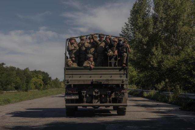 Ukrainian soldiers drive in a military truck along a road in the Kharkiv region on July 30, 2026, amid the Russian invasion of Ukraine. (Photo by Roman PILIPEY / AFP)