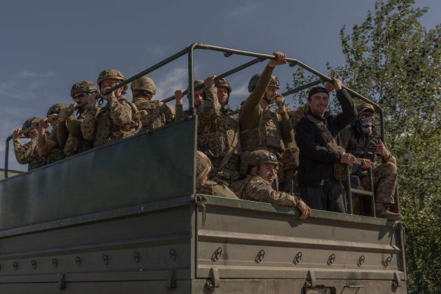 Ukrainian soldiers drive in a military truck along a road in the Kharkiv region on July 30, 2026, amid the Russian invasion of Ukraine. (Photo by Roman PILIPEY / AFP)
