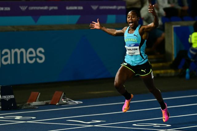Bahamas' Devynne Charlton celebrates as she crosses the finish line to win the women's 100m hurdles final during the athletics event at the Scotstoun Stadium in Glasgow, on day seven of the Commonwealth Games in Glasgow, Scotland, on July 30, 2026. (Photo by Ben STANSALL / AFP)