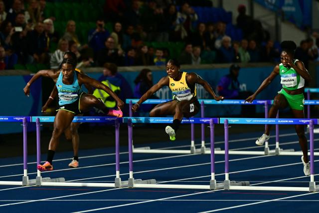 (From L) Bahamas' Devynne Charlton, Jamaica's Megan Simmonds and Nigeria's Tobi Amusan compete in the women's 100m hurdles final during the athletics event at the Scotstoun Stadium in Glasgow, on day seven of the Commonwealth Games in Glasgow, Scotland, on July 30, 2026. (Photo by Ben STANSALL / AFP)