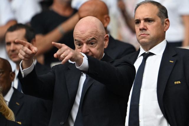 (FILES) FIFA President Gianni Infantino (L) and CONCACAF President Victor Montagliani attend the 2026 World Cup football tournament quarter-final match between Norway and England at Miami Stadium in Miami on July 11, 2026. CONCACAF, which comprises 41 football associations from North America, Central America and the Caribbean, formally rejected FIFA’s proposal to open up the organisation to private investors on Thursday, it announced following a meeting of its members. (Photo by ROBERTO SCHMIDT / AFP)