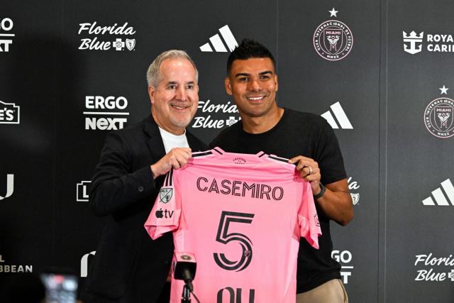 Brazilian midfielder Casemiro poses with Inter Miami managing owner and CEO Jorge Mas as he's officially introduced as Inter Miami's new signing during an event at NU Stadium in Miami, Florida, on July 30, 2026. Casemiro, who has 91 caps for Brazil and won five Champions League titles with Spain's Real Madrid, was a free agent after Manchester United opted not to renew his contract following a mixed four-year stint at the Premier League giants. (Photo by CHANDAN KHANNA / AFP)