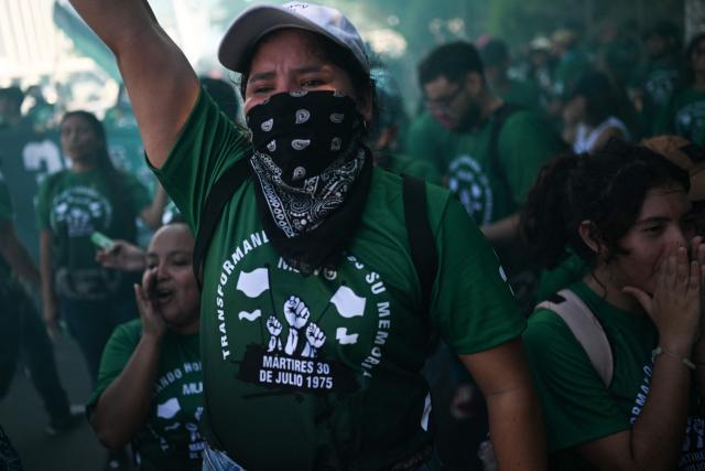 Demonstrators take part in a march to commemorate the 51st anniversary of the 1975 Salvadoran student massacre in San Salvador on July 30, 2026. On July 30, 1975, a protest march against the military occupation of a campus of the state-run University of El Salvador (UES) was dispersed by police using armored vehicles and gunfire during the administration of late Colonel Arturo Armando Molina (1972-1977), with university authorities reporting that around 50 students were killed and dozens disappeared. (Photo by Marvin RECINOS / AFP)