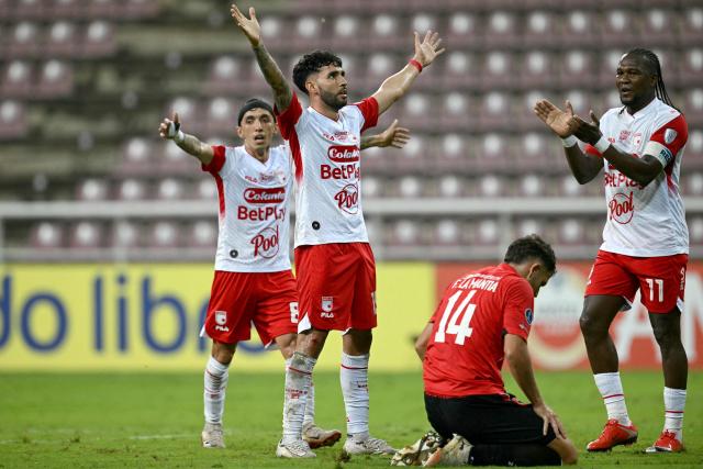 Santa Fe's Argentine forward #19 Nahuel Bustos celebrates his team’s first goal with Santa Fe's forward #11 Hugo Rodallega during the second leg of the Copa Sudamericana knockout round play-off football match between Venezuela's Caracas and Colombia's Independiente Santa Fe, at the Metropolitano de Cabudare stadium, in Barquisimeto, state of Lara, Venezuela, on July 30, 2026. (Photo by Federico PARRA / AFP)