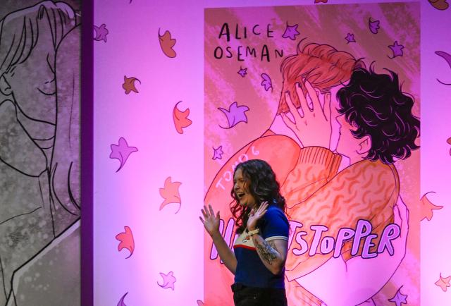 British author of Heartstopper Alice Oseman waves during the presentation of the latest book in the Heartstopper saga at the Esperanza Iris Theater in Mexico City on July 30, 2026. The Heartstopper saga was adapted into a Netflix TV series and recently into a movie on the same platform. (Photo by Alfredo ESTRELLA / AFP)