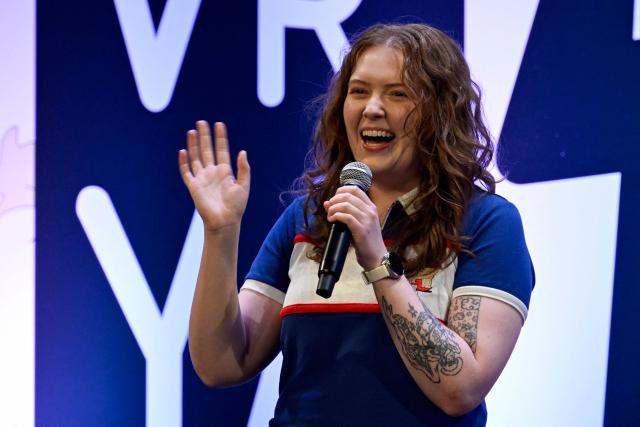 British author of Heartstopper Alice Oseman waves during the presentation of the latest book in the Heartstopper saga at the Esperanza Iris Theater in Mexico City on July 30, 2026. The Heartstopper saga was adapted into a Netflix TV series and recently into a movie on the same platform. (Photo by Alfredo ESTRELLA / AFP)