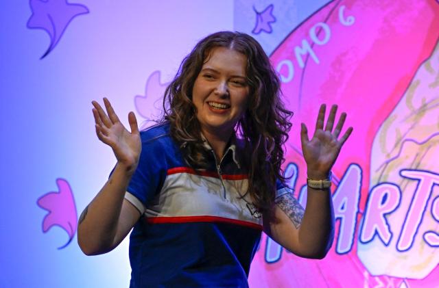 British author of Heartstopper Alice Oseman waves during the presentation of the latest book in the Heartstopper saga at the Esperanza Iris Theater in Mexico City on July 30, 2026. The Heartstopper saga was adapted into a Netflix TV series and recently into a movie on the same platform. (Photo by Alfredo ESTRELLA / AFP)