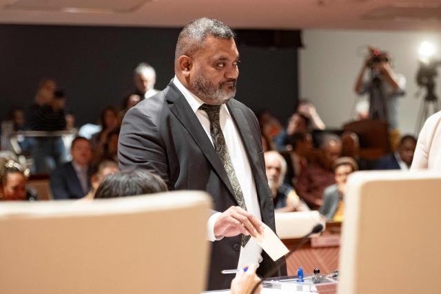 Milakulo Tukumuli, candidate presented by the Le Rassemblement group, casts his vote during a formal session to elect members of the Government of New Caledonia at the Congress in Noumea on July 31, 2026. (Photo by Delphine Mayeur / AFP)