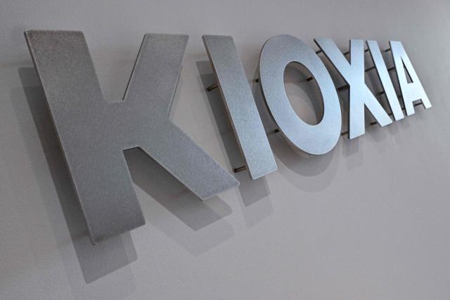 (FILES) This photo shows a general view of signage at the entrance to Kioxia, the world's third largest manufacturer of NAND flash memory chips, at their headquarters building in central Tokyo on August 23, 2024. Ferocious AI-driven demand delivered quarterly net profit more than 45 times higher than last year's figure for Japanese chipmaker Kioxia, the company said on July 31, 2026. (Photo by Richard A. Brooks / AFP)
