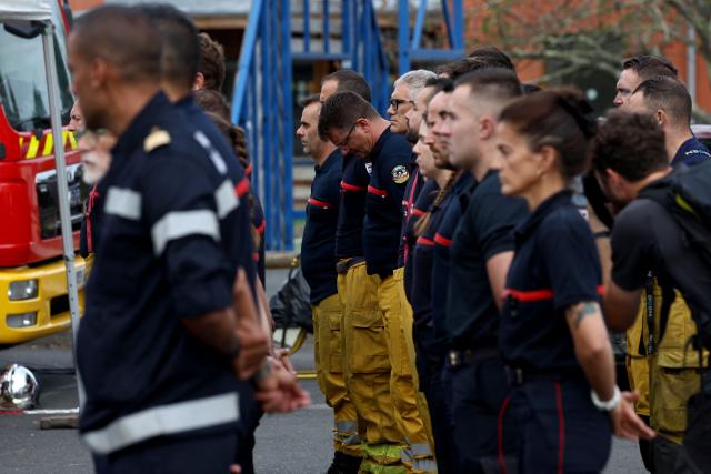 Firefighters stand in silence during a moment of respect for the memory of their comrades killed while combatting a forest fire in Merignac three days before, at their base in Lège-Cap-Ferret, near Bordeaux, on July 31, 2026. (Photo by ROMAIN PERROCHEAU / AFP)