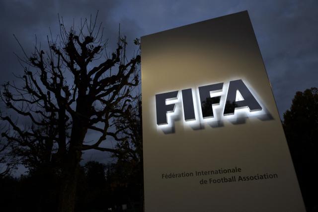 (FILES) This photo taken on October 8, 2015 in Zurich shows the entrance sign with the logo at the FIFA world headquarters. World football's governing body FIFA vowed on July 31, 2026 to press ahead with an "open and democratic" consultation on a proposed private investment plan despite widespread opposition to the proposal. (Photo by Fabrice COFFRINI / AFP)