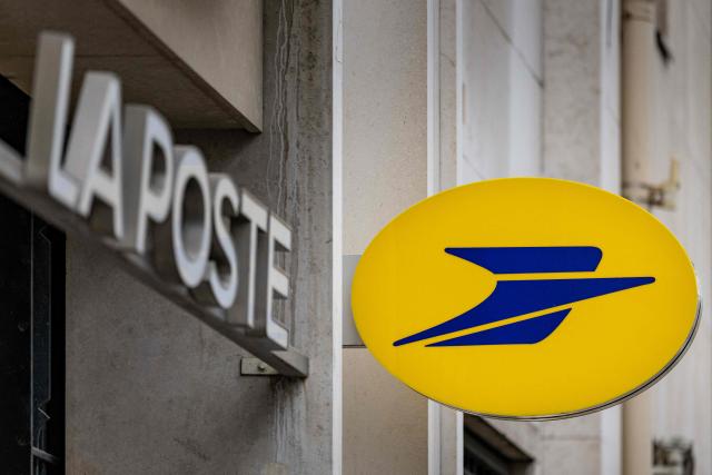 (FILES) This photograph shows the logo of French postal service La Poste in Paris on July 30, 2026. La Poste announced a profit of Ђ457 million for the first half of the year on July 31, 2026, a 36.5% drop due to an accounting effect—but its revenue rose by 3.3%, driven by parcel services and its financial division. (Photo by Joel Saget / AFP)