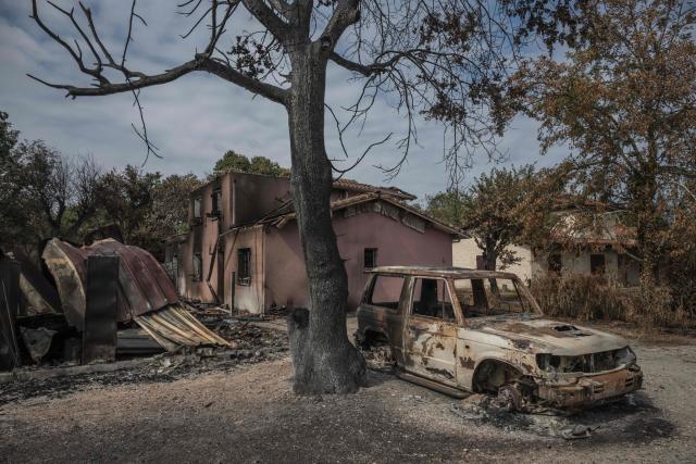 This general view shows a burnt car before a house destroyed by fire, in Le Porge, south-western France on July 31, 2026, as a wildfire has been ravaging the forest north of the Arcachon Basin (Gironde) since July 22. (Photo by Ed JONES / AFP)