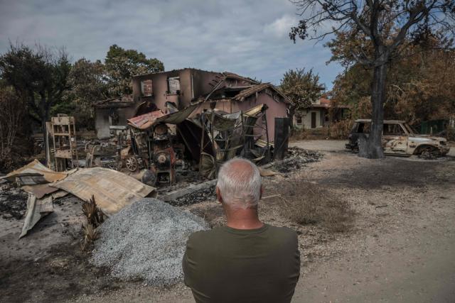 Bruno, 60, stands before his home which was destroyed by fire, in the village of Le Porge, south-western France on July 31, 2026, as a wildfire has been ravaging the forest north of the Arcachon Basin (Gironde) since July 22. (Photo by Ed JONES / AFP)