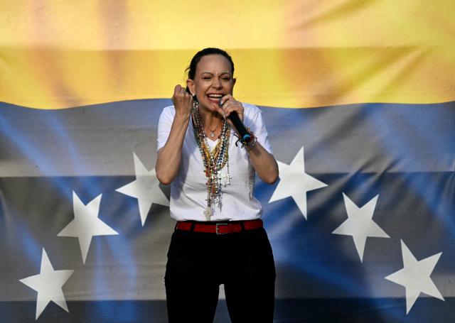(FILES) Venezuelan opposition leader Maria Corina Machado speaks to supporters on stage in Madrid's Puerta del Sol on April 18, 2026. It is “essential” that opposition leader Maria Corina Machado takes part in the political dialogue due to begin on August 1, 2026 in Venezuela, said Alejandro Fleming, a former minister under the ousted Nicolas Maduro and his predecessor Hugo Chavez, in an interview with AFP. (Photo by Javier SORIANO / AFP)