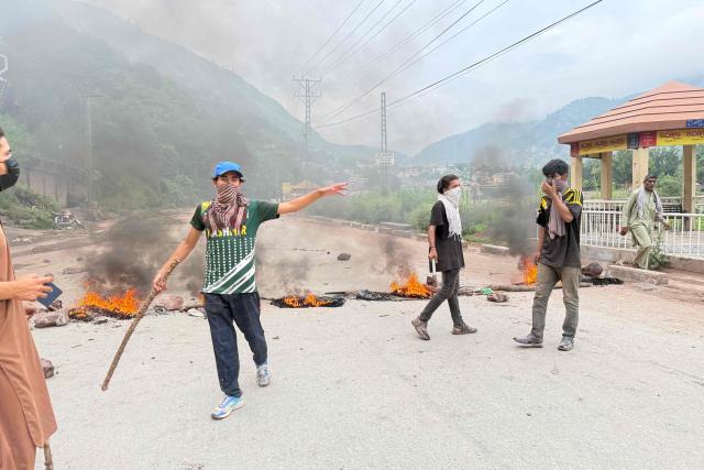 Protestors burn tyres along a road after clashes with police in Muzaffarabad on July 31, 2026 amid unrest during the first phase of voting for the local legislature in Pakistan-administered Kashmir. Protesters and security personnel engaged in deadly clashes in Pakistan-administered Kashmir as the sensitive Himalayan region goes to the polls, an official said on July 28. (Photo by Sajjad QAYYUM / AFP)
