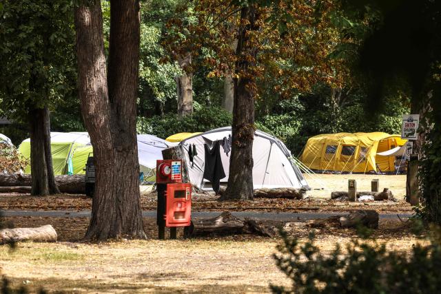 An abandoned camp site is pictured, following a wildfire, at Dunwich Heath in eastern England on July 31, 2026. Firefighters in eastern England were "making good progress" Thursday battling a "dynamic" wildfire which has engulfed swathes of heathland and prompted the evacuation of dozens of residents and visitors, local officials said. (Photo by Humphrey Nemar / POOL / AFP)