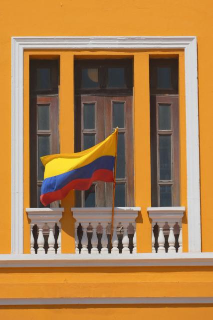 A Colombian national flag flutters from a balcony of the historic Customs building, which was chosen by Colombia's President-elect, Abelardo de la Espriella, as one of the alternative locations from which he will conduct official business as head of state, in Barranquilla, Colombia, on July 30, 2026. De la Espriella will take office on August 7, 2026. (Photo by Vanexa Romero / AFP)