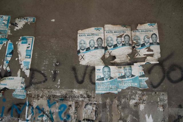 Political campaign posters from 2016 are visible on a wall in the city center in Port-au-Prince, Haiti, on July 31, 2026. Haiti's electoral council on July 27, 2026, set December 13 as the date for the crisis-wracked nation's first elections in a decade, pending the establishment of an "acceptable security environment." Elections have not been held in Haiti since 2016, and the country's last elected president, Jovenel Moise, was assassinated in 2021. (Photo by Clarens SIFFROY / AFP)