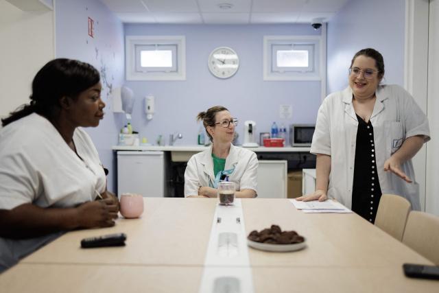 (From L) The Unité d'Accueil Pédiatrique Enfants en Danger (UAPED) head of department Barkissa Bance, pediatrician doctor Christelle Pierrot and nurse Celine Cazaux speak to each other at the department in the Centre Hospitalier Sud Francilien (CHSF) in Corbeil-Essonnes, southern suburbs of Paris on June 30, 2026. Accueil Pédiatrique Enfants en Danger (UAPED, Pediatric Emergency Care for Children at Risk) is a specialised multidisciplinary unit that provides protection, medical care and support for children and adolescents suspected to be victims of violence, abuse or neglect. (Photo by Simon WOHLFAHRT / AFP)