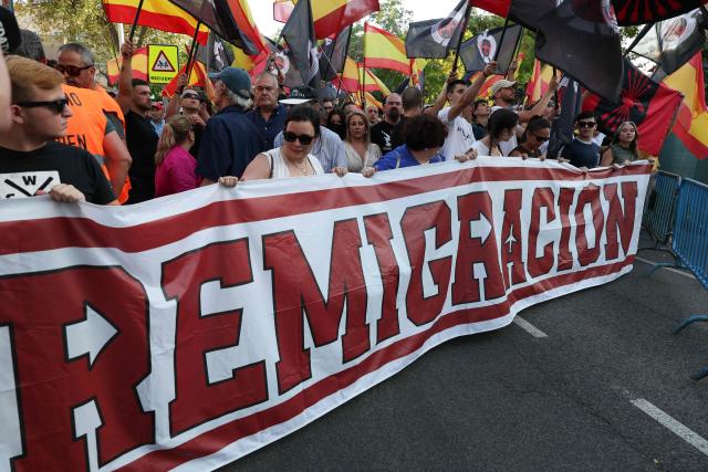 Far-right demonstrators protest against the mass arrival of Moroccan migrants in Ceuta, in Madrid on July 31, 2026. Hundreds of anti-migrant protesters rallied outside Morocco's embassy in Madrid on July 31 to denounce what they called a migrant "invasion" of Spain's north African enclave of Ceuta. (Photo by Pierre-Philippe MARCOU / AFP)