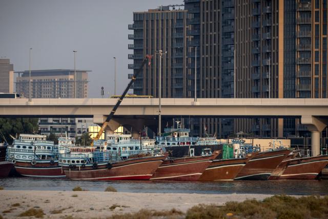 Vessels are anchored in the waters at Dubai on July 31, 2026. On February 28, Israel and the United States launched strikes on Iran killing its supreme leader and triggering a war that spread across the Middle East and unleashed chaos across global markets and sent oil prices soaring and throwing the region into chaos as Iran and the United States battle for control of the Strait of Hormuz water way. (Photo by AFP) / 