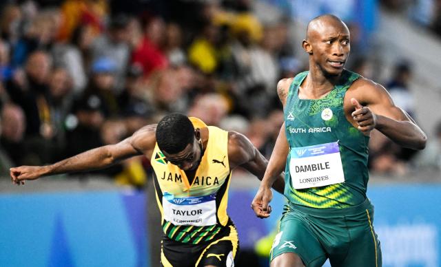 South Africa's Sinesipho Dambile (R) crosses the finish line past Jamaica's Christopher Taylor to win the men's 200m final during the athletics event at the Scotstoun Stadium in Glasgow, on day eight of the Commonwealth Games in Glasgow, Scotland, on July 31, 2026. (Photo by ANDY BUCHANAN / AFP)