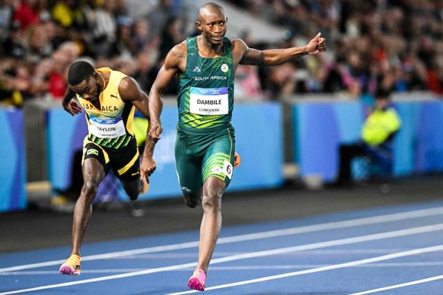 South Africa's Sinesipho Dambile (R) crosses the finish line past Jamaica's Christopher Taylor to win the men's 200m final during the athletics event at the Scotstoun Stadium in Glasgow, on day eight of the Commonwealth Games in Glasgow, Scotland, on July 31, 2026. (Photo by ANDY BUCHANAN / AFP)