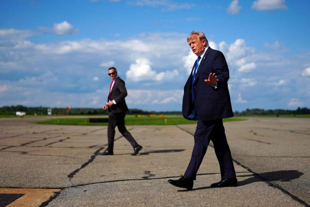 US President Donald Trump gestures after stepping off Air Force One upon arrival at Morristown Municipal Airport in Morristown, New Jersey, on July 31, 2026. President Trump arrived in New Jersey to spend the weekend at his National Golf Club in Bedminster, following a cabinet meeting in Camp David, Maryland. (Photo by Aaron Schwartz / AFP)