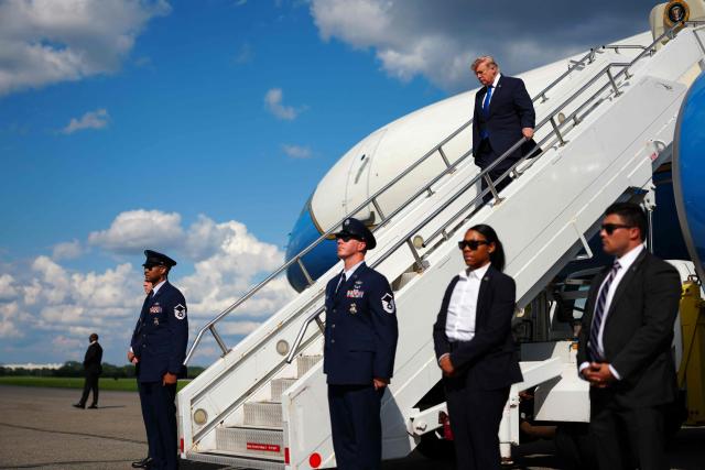 US President Donald Trump steps off Air Force One upon arrival at Morristown Municipal Airport in Morristown, New Jersey, on July 31, 2026. President Trump arrived in New Jersey to spend the weekend at his National Golf Club in Bedminster, following a cabinet meeting in Camp David, Maryland. (Photo by Aaron Schwartz / AFP)