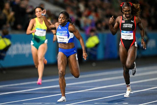 British Virgin Islands' Adaejah Hodge (L) celebrates as she crosses the finish line past Trinidad and Tobago's Shaniqua Bascombe (R), to win in the women's 200m final during the athletics event at the Scotstoun Stadium in Glasgow, on day eight of the Commonwealth Games in Glasgow, Scotland, on July 31, 2026. (Photo by ANDY BUCHANAN / AFP)