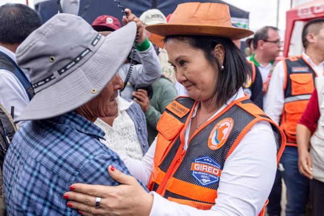 Peru's President Keiko Fujimori greets local residents during a visit to the community of Pumpuya, in the district of Chongos Bajo on the outskirts of Huancayo, about 300 km east of Lima, on July 31, 2026, following a 5.1-magnitude earthquake. Peru's government declared a state of emergency on July 20 to provide assistance to areas affected by an earthquake that struck on July 18, killing at least six people and destroying about 50 homes in Andean communities in the country's central region. (Photo by JAVIER NINANYA / AFP)